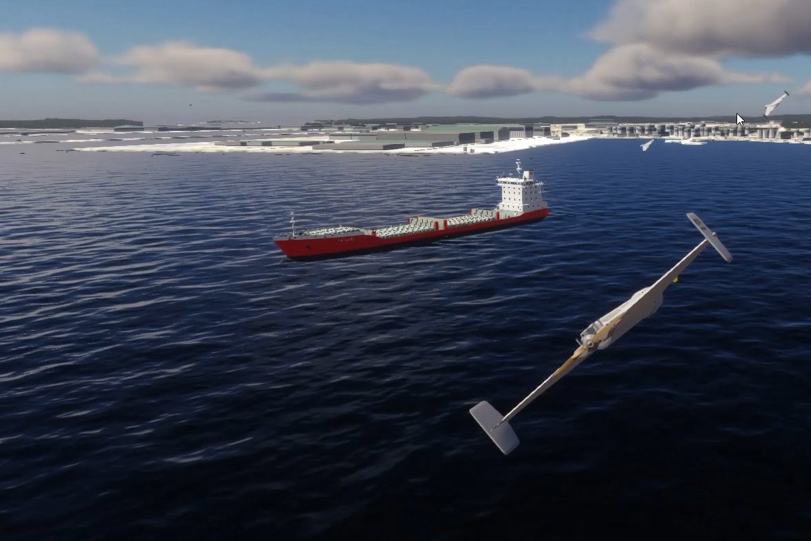 A fixed-wing drone over open water, a cargo ship under way and a harbor town on the horizon.